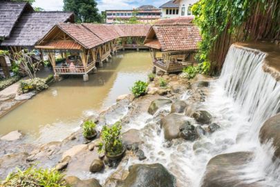 A stunning waterfall in a quaint village, blending nature's beauty with local charm. — Atria Tourist