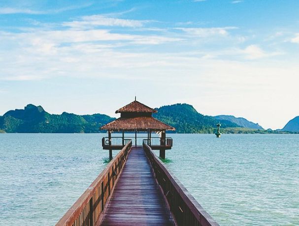 Get serenity at a cozy hut on a wooden pier. Escape with Atria Tourist, your top tour agency.