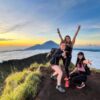 Three women snap a mountaintop pic, celebrating their adventure with Atria Tourist, top tour agency.