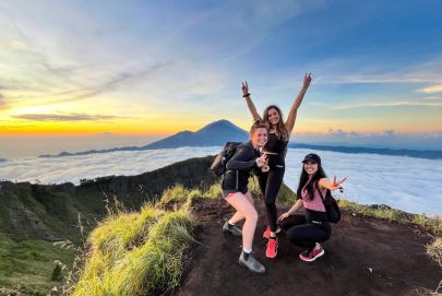 Three women snap a mountaintop pic, celebrating their adventure with Atria Tourist, top tour agency.