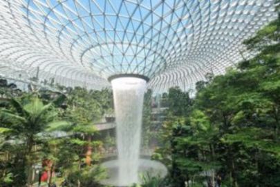 Lush indoor garden with a tranquil waterfall, crafted by Atria Tourist, the top tour agency.